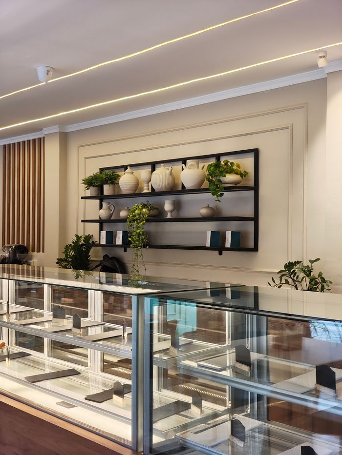 pexels photo 35630878 35630878 Elegant bakery interior in Thrissur, India with a modern glass display and decorative elements.