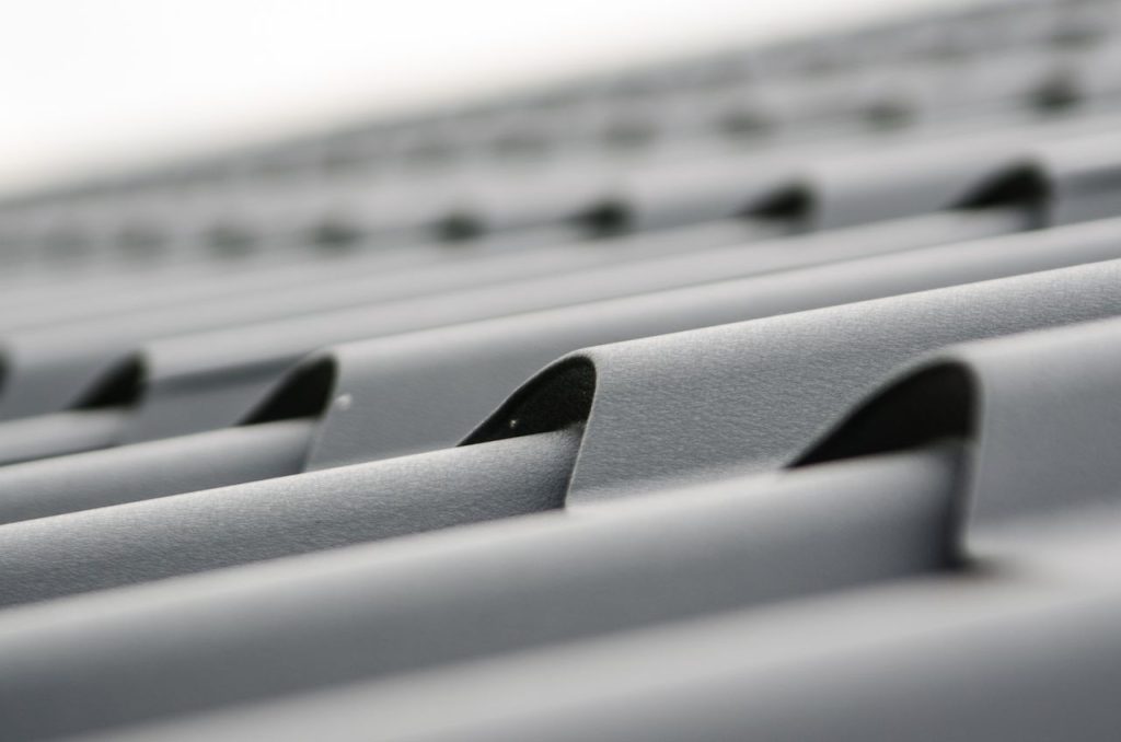 roof plate tiles brick black 48895 48895 Detailed close-up of grey metal roof sheets showcasing texture and design.